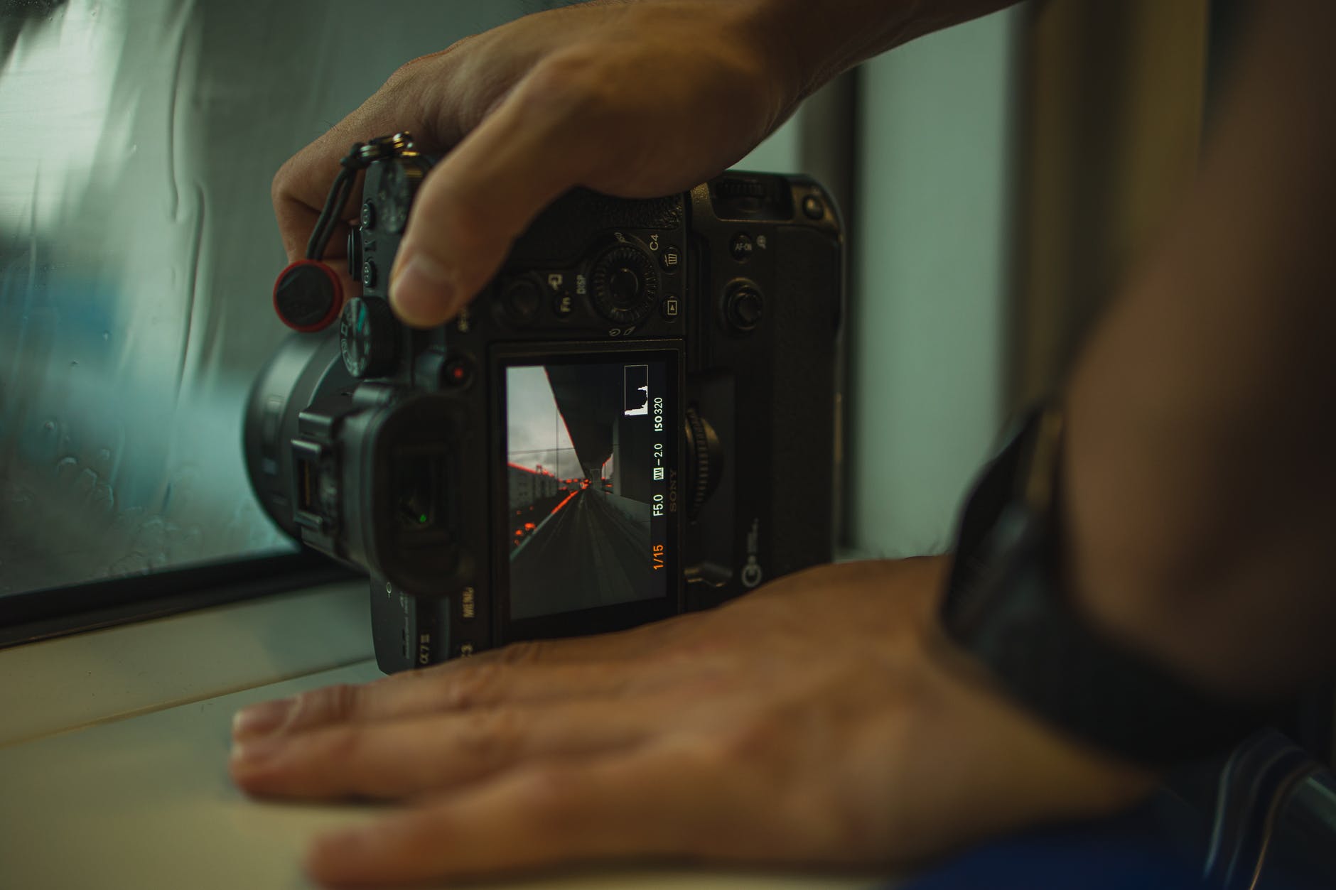 crop unrecognizable photographer showing road on photo camera screen